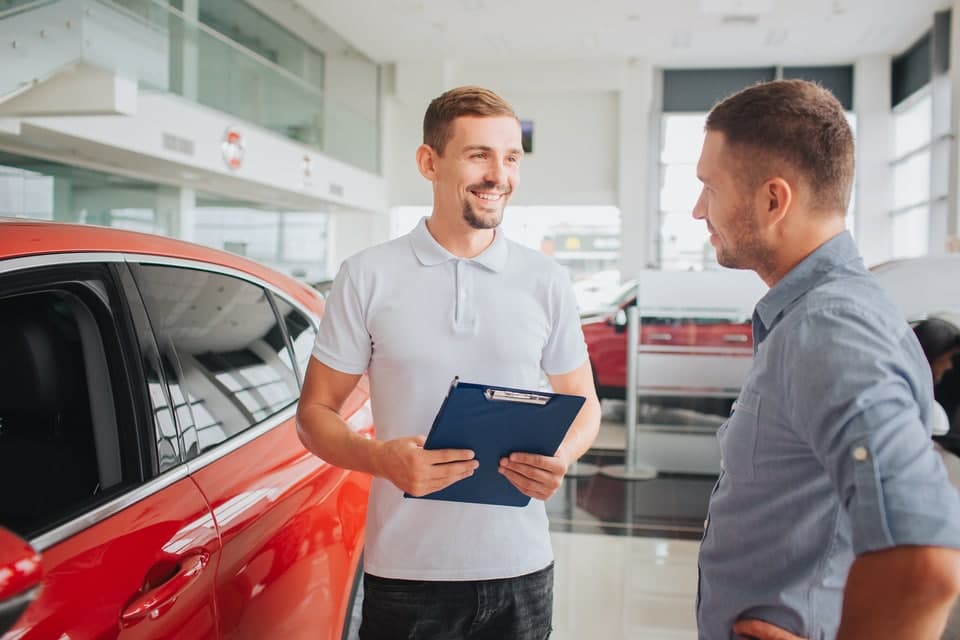 Shopper speaking with a Lincoln of Memphis dealership employee in a showroom