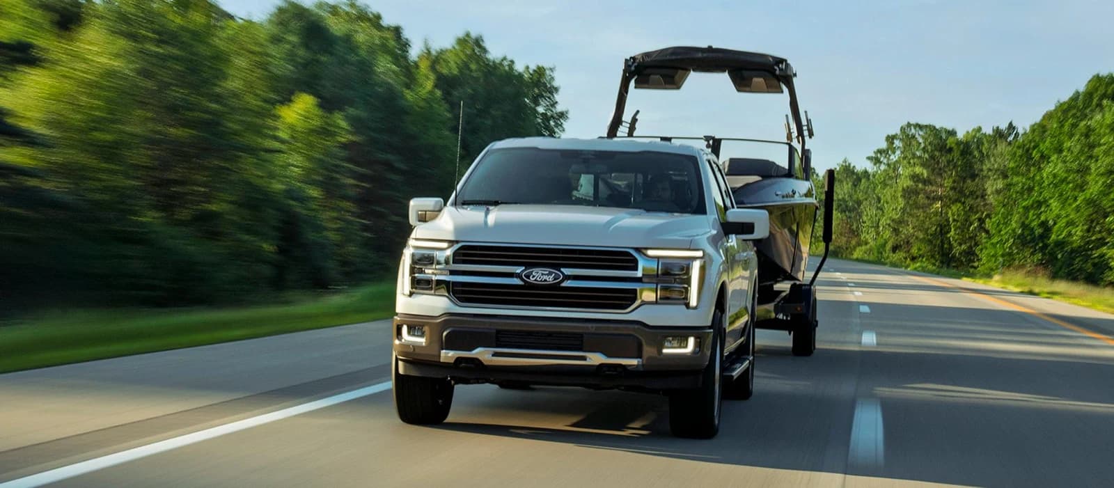 2027 Ford F-150 Lariat towing a boat