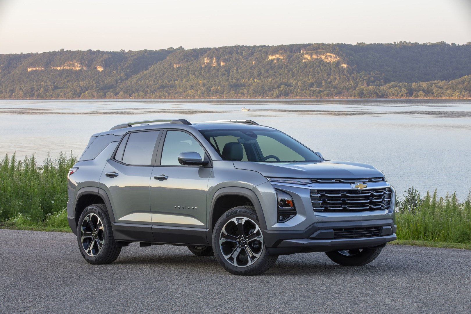 Silver Chevrolet Equinox parked beside a lake.