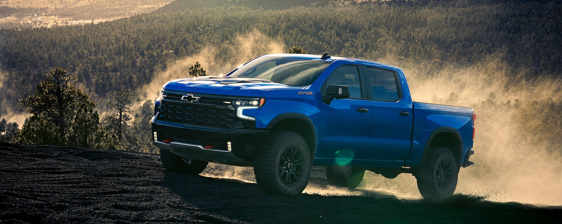 Blue Chevrolet Silverado ZR2 on rocky terrain in Chevrolet manufacturer photography.